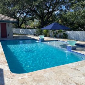 Backyard pool area with sun shelf.