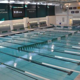 Loyola University indoor competition pool with swimming lanes. Diamond Brite Marlin Blue exposed aggregate pool finish.