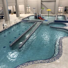 Indoor community pool with kids playscape.