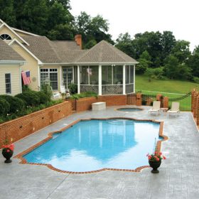 Backyard pool area in a cottage type setting.