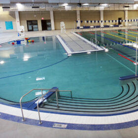 An indoor swimming facility with kids area and swim lanes.